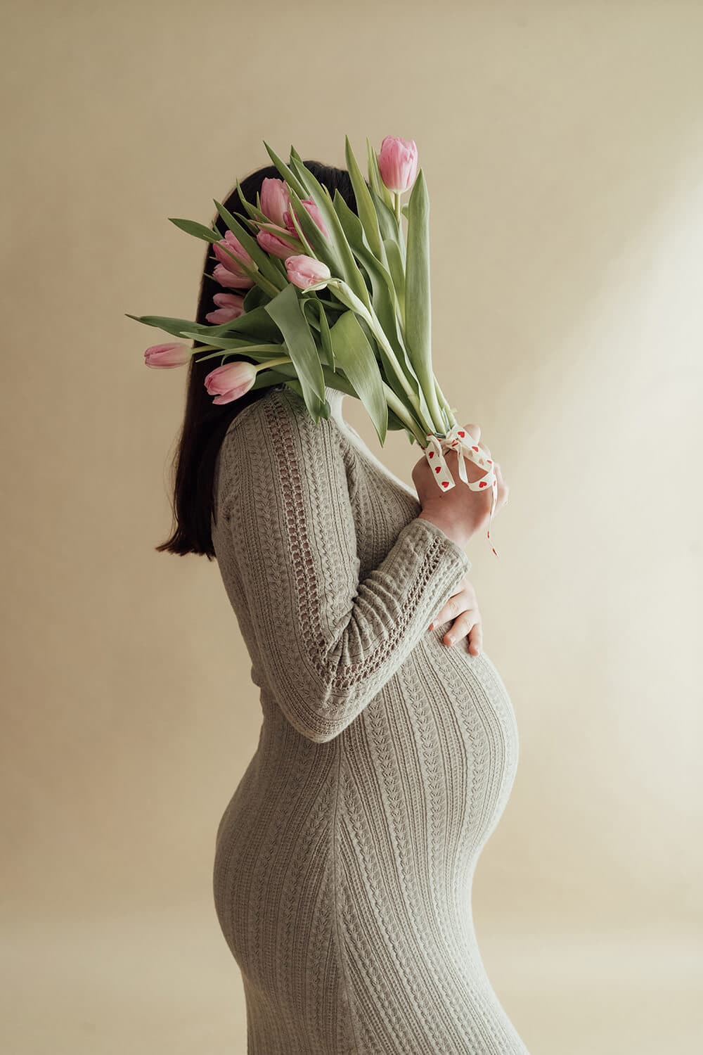 Editorial style maternity photo in a minimalist studio setting